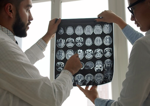 Two doctors examine brian scans